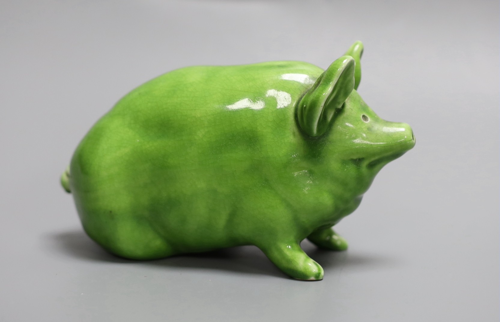 A Wemyss ware pig, decorated in lime green glaze and impressed to the base Wemyss ware RH & S, for Robert Heron & Son of Fife, 16.5cm long, 10cm high.